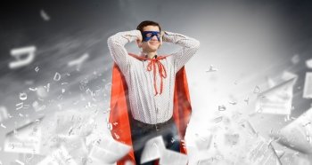 Frustrated superman Young man in hero costume closing ears with palms