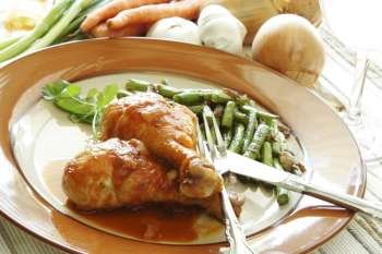 Chicken legs baked in tomato sauce with green beans on the side