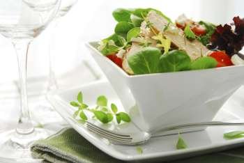 Fresh green salad with grilled chicken herbs and tomatoes  close up