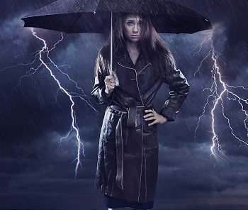 Single woman wearing coat holding umbrella Creative szmbol of the bad weather
