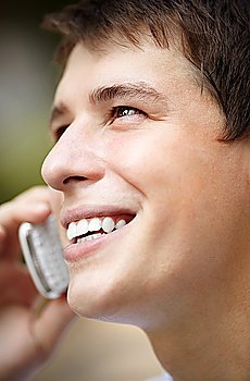 portrait of young man with cell-phone  ambient light and silver reflection for natural look