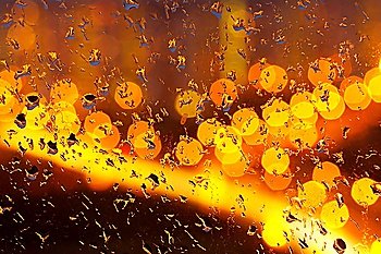 Drops of a rain on glass at night