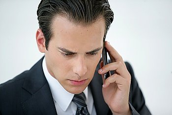 A concerned businessman talking on his mobile phone