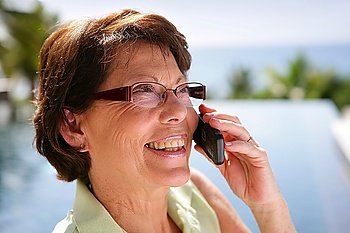 Mature woman outdoors on the phone