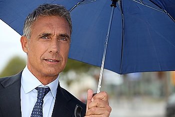 Businessman with an umbrella