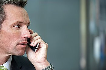 Businessman using cell phone portrait