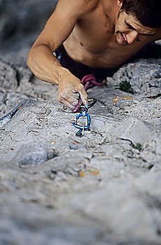 Rock climber struggling on cliff