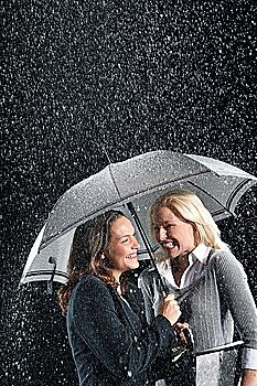 Businesswomen Standing Under Umbrella