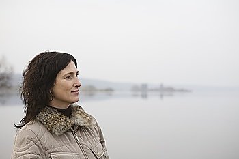 Woman standing near lake