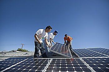 A group of men lifting a large solar panel
