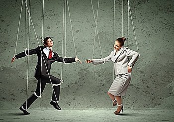 Image of businesspeople hanging on strings like marionettes Conceptual photography