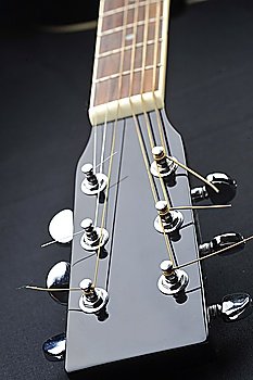 Details of  acoustic black guitar neck  nut  frets  strings