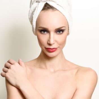 Beautiful blond woman with white towel on her head Young girl with blue eyes and red lips