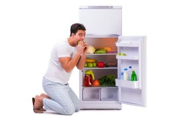 Man next to fridge full of food The man next to fridge full of food