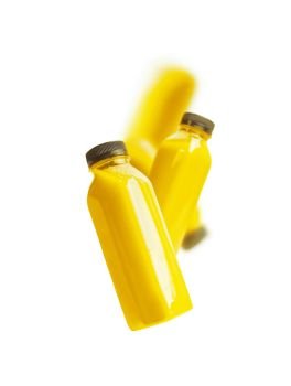 Flying yellow smoothie or juice bottle   isolated on white background Branding copy space