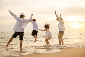 Happy Asian family have fun jumping together on beach in holiday at sunset time  Silhouette of family holding hands live healthy lifestyle on beach  b