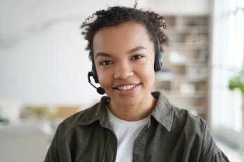 Smiling biracial young female student in headset with microphone learning foreign language online  friendly african american teen girl in headphones l