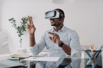 Businessman in vr headset clicks virtual buttons Freelancer is working on design project African american man in futuristic vr headset at home Mode