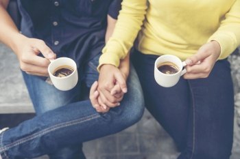 Couple lover having date and drinking a cup of coffee together happy relation on cafe coffee lover concept Close up woman hands holding cup of coff