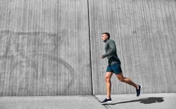 fitness  sport and healthy lifestyle concept - young man running outdoors young man running outdoors