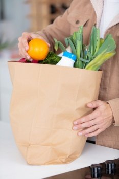 close view of paper bag of groceries on worktop