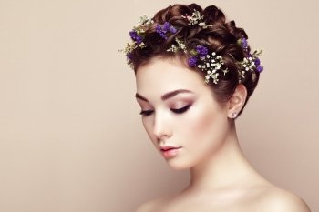 Face of beautiful woman decorated with flowers Perfect makeup Beauty fashion Eyelashes Cosmetic Eyeshadow