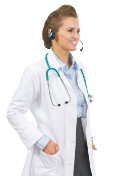 Smiling doctor woman in headset looking on copy space