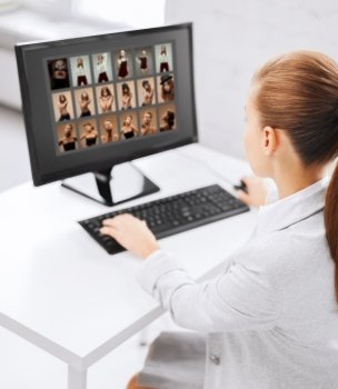 photography  office and magazine concept - editor choosing pictures from computer monitor