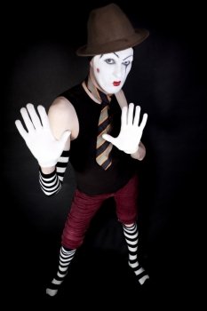 mime in  hat   tie and white gloves on  black background