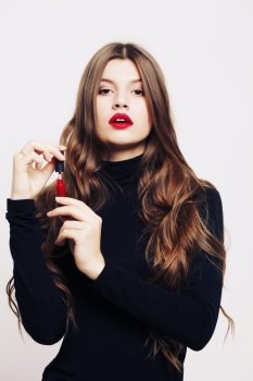 Beautiful girl with long wavy healthy hair Brunette with curly hairstyle  and professional makeup  red lips