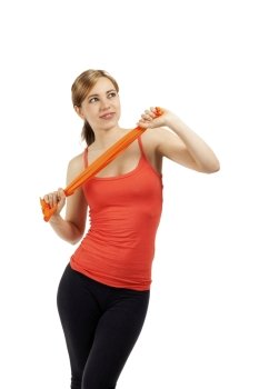 young fitness woman train with a ribbon beautiful young fitness woman train with a orange ribbon on white background