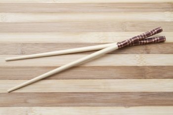 chopsticks isolated on wood background