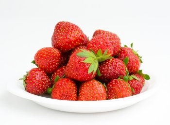 fresh garden strawberries on a white plate