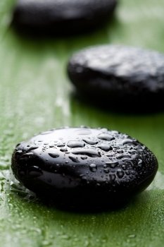 black spa stones over leaf