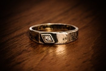 old silver ring on wooden table